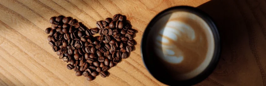 Roasted coffee beans and a world map illustrating coffee production and consumption facts