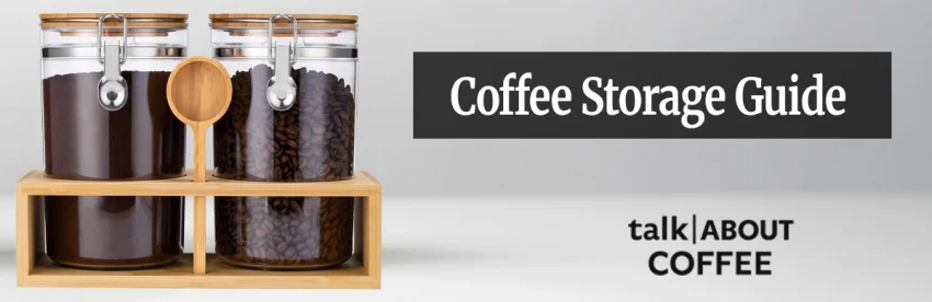 Whole coffee beans being poured from a kraft bag into an opaque airtight storage canister on a wooden kitchen counter