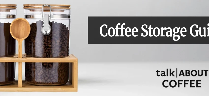 Whole coffee beans being poured from a kraft bag into an opaque airtight storage canister on a wooden kitchen counter