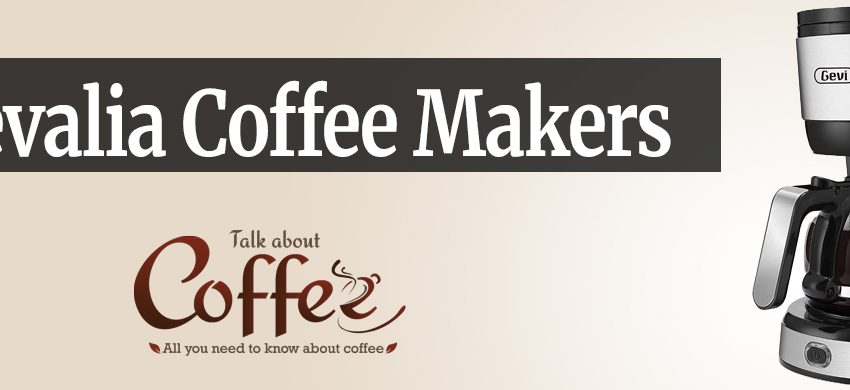 Stainless steel and black drip coffee maker with a glass carafe of brewed coffee on its warming plate