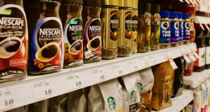 Assorted coffee brand labels and packaging from major American supermarket coffee brands