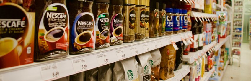 Assorted coffee brand labels and packaging from major American supermarket coffee brands