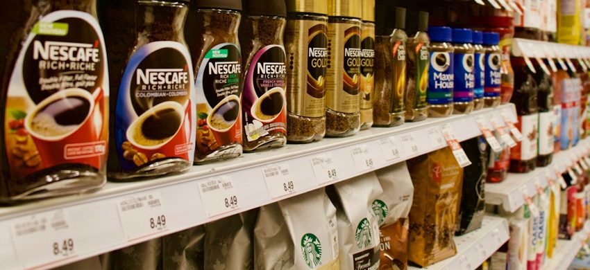 Assorted coffee brand labels and packaging from major American supermarket coffee brands