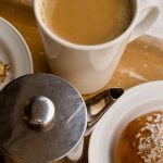 Cinnamon buns and a cup of coffee served together on a tray for fika
