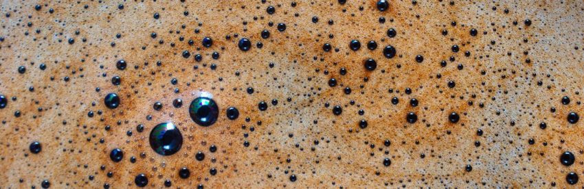 Macro closeup of espresso crema with visible bubbles