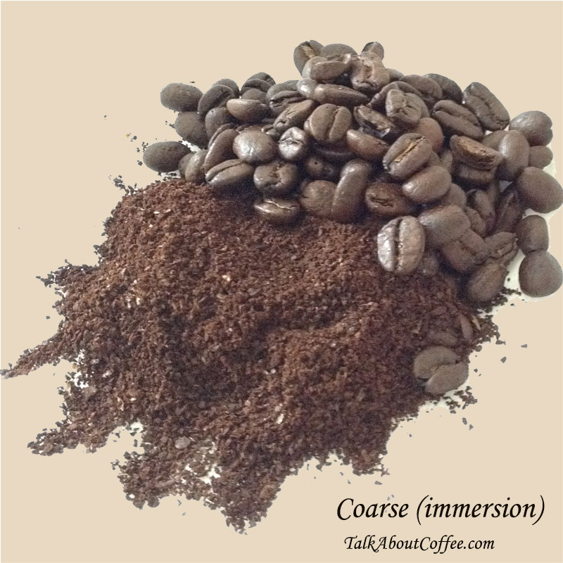 Coarsely ground coffee beside whole beans, the grind used for French press and cold brew