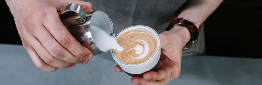 ilk being poured into a cup of coffee