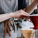 pouring water into coffee maker