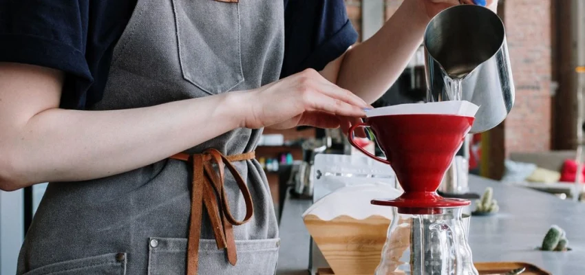 pouring water into coffee maker