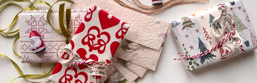 Wrapped Christmas gifts on a table for a white elephant or Secret Santa coffee gift exchange