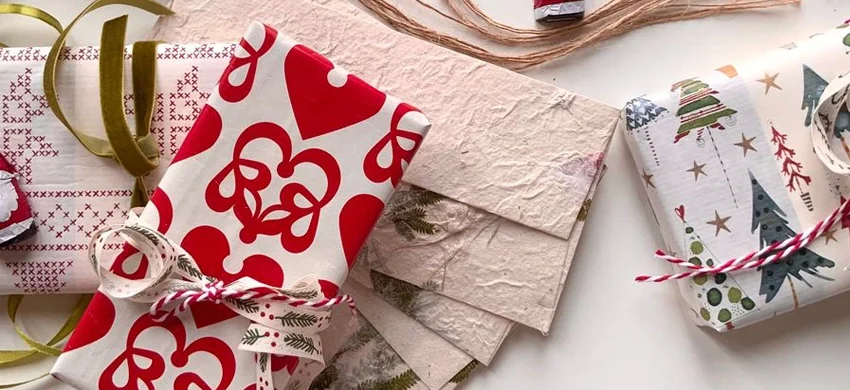 Wrapped Christmas gifts on a table for a white elephant or Secret Santa coffee gift exchange